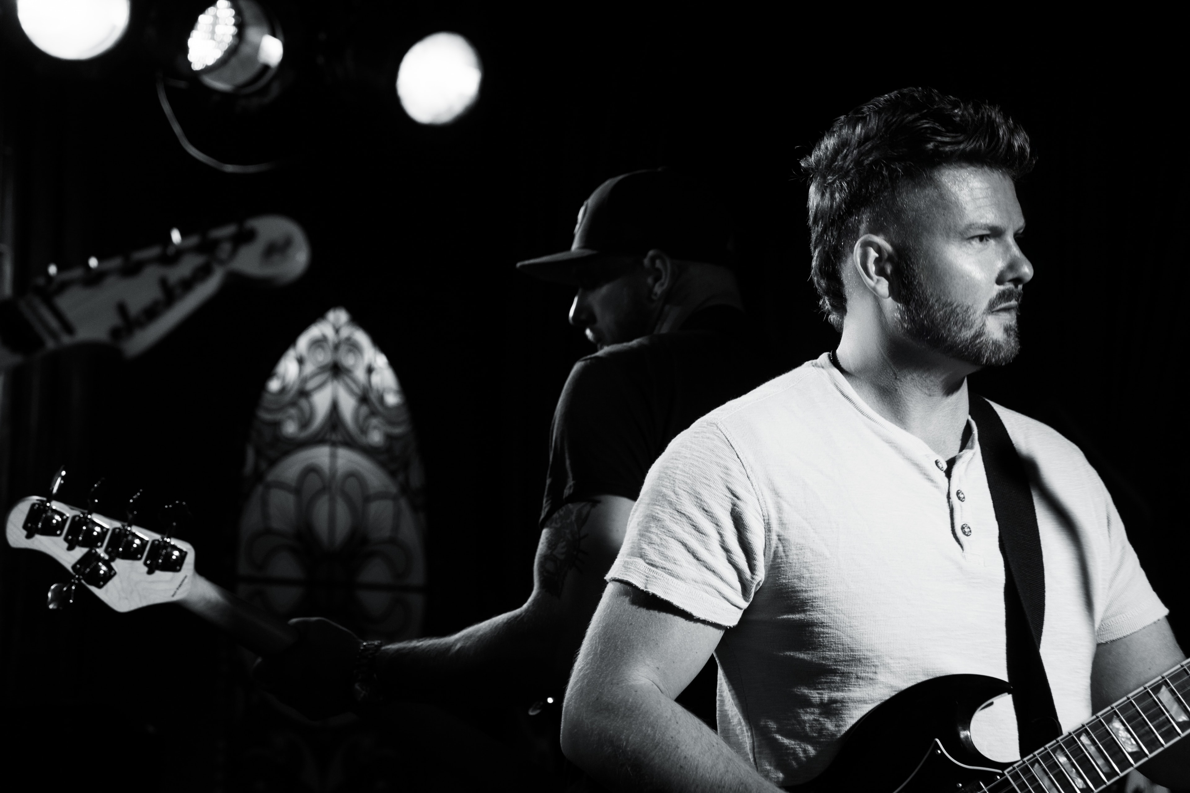 Rise Up Revival guitarist performing — black and white