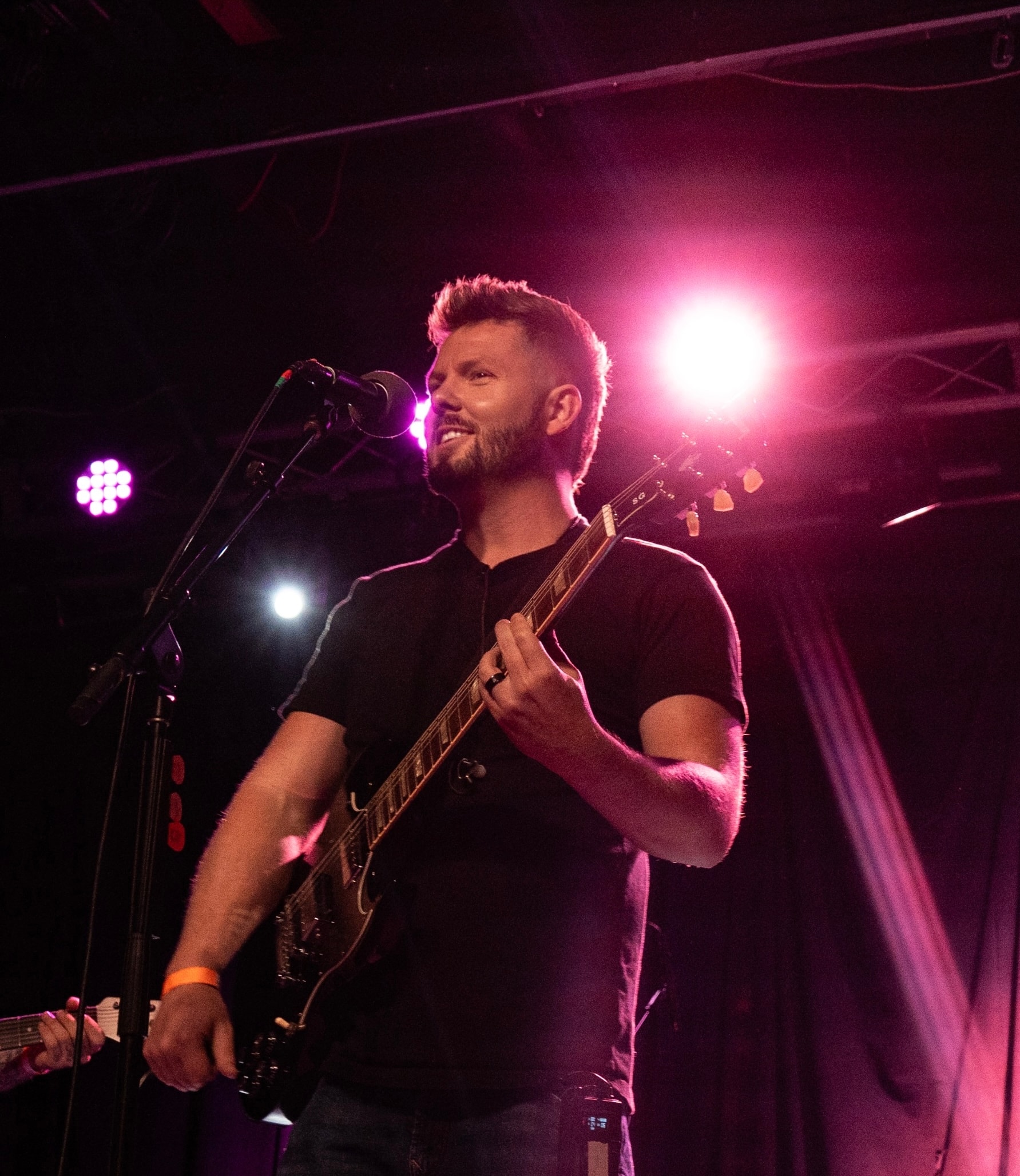 Rise Up Revival vocalist under pink stage lights